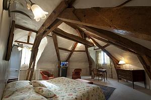 Large attic room with beamed ceiling