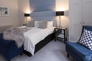 Spacious room with chair and ottoman