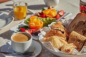 Breakfast fruit, bread, pastries, cold meats, cheese